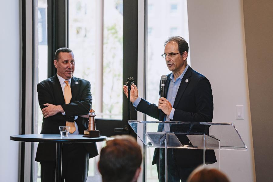 District Attorney Dan Rubenstein and Colorado Attorney General Phil Weiser stand at a lectern at Colorado Mesa University. Weiser was recognized by the university and Mesa County for his support of a juvenile diversion program on the Western Slope.